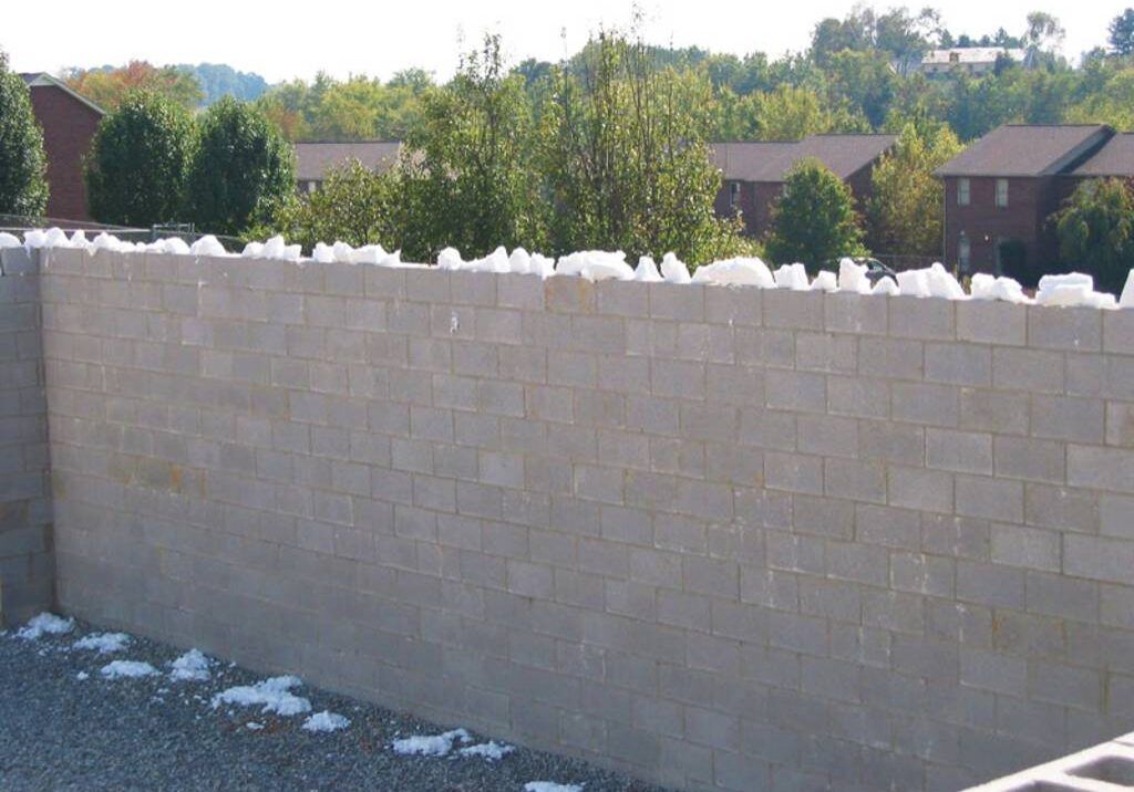 Foam-in-place insulation filling a concrete block wall