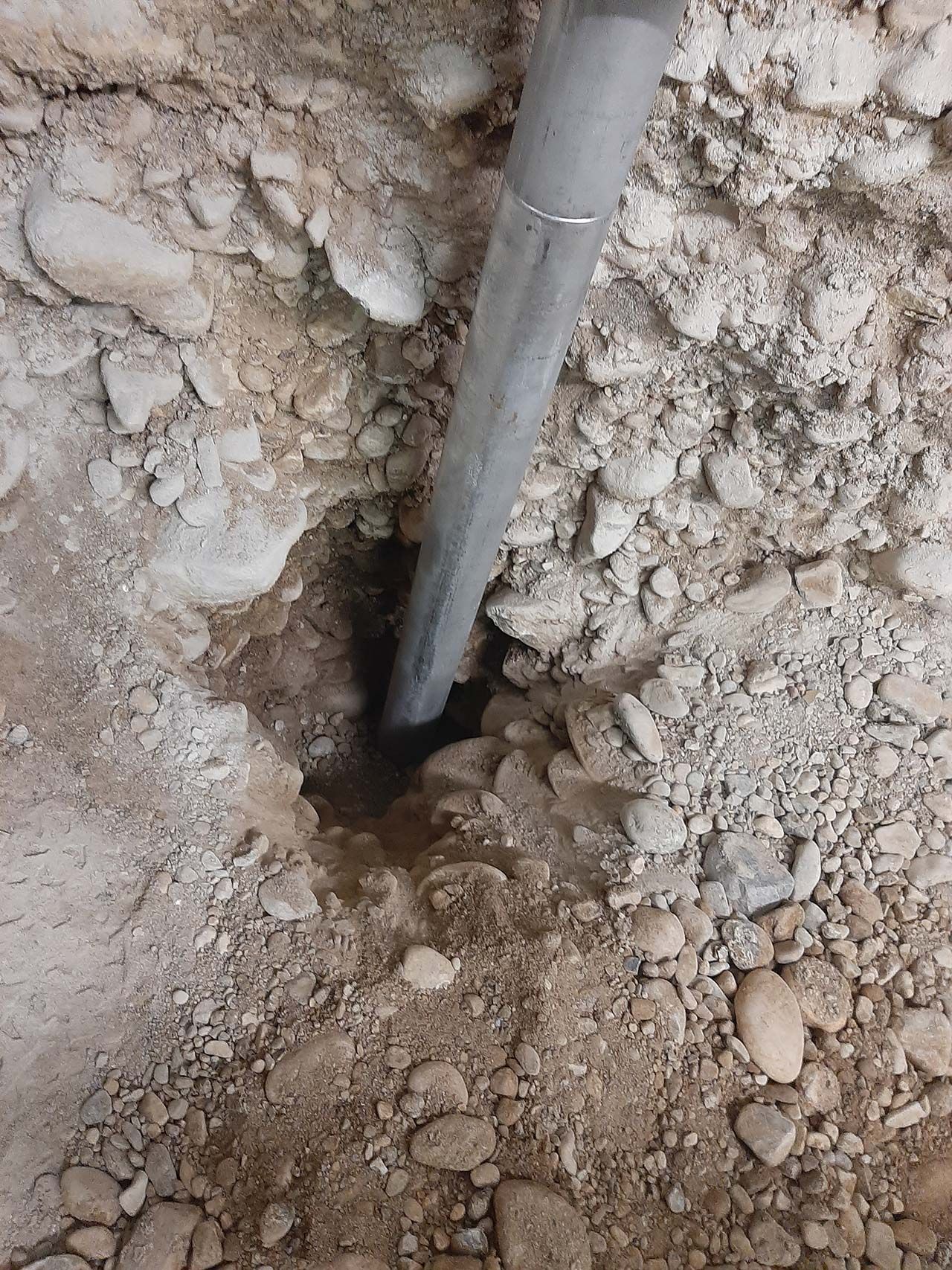 Steel pier driven deep into cobbly Cache Valley soil